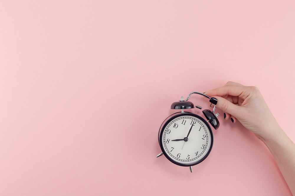 9-natural-ways-to-get-a-better-nights-sleep-alarm-clock-pink-background.jpg