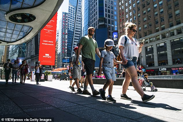 Experts say the recommendations gave an incentive for vaccine-hesitant people to get their coronavirus shot. Pictured: People without masks walk in New York's Times Square, May 19
